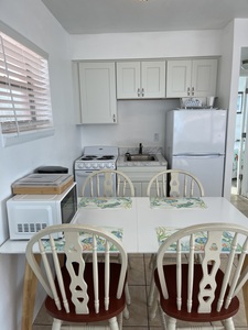 Room 34 Kitchen and Dining Area with Appliances and Dining Table