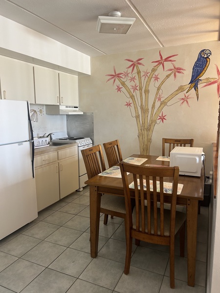 Kitchen with oven/stove, refrigerator, dining table and chairs