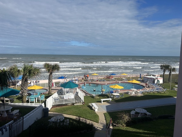 Pool and oceanfront view from balcony