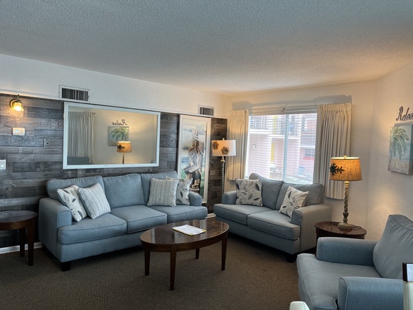 Beautiful New living room sleeper sofa, loveseat, beach-themed artwork